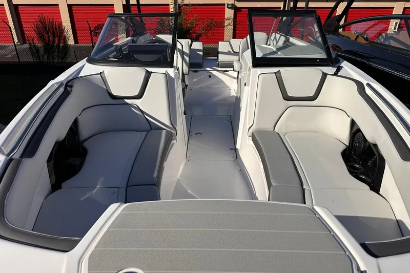Slide: The Image of 2025 Yamaha Boats AR250 interior with sleek white seating and modern design. - 25