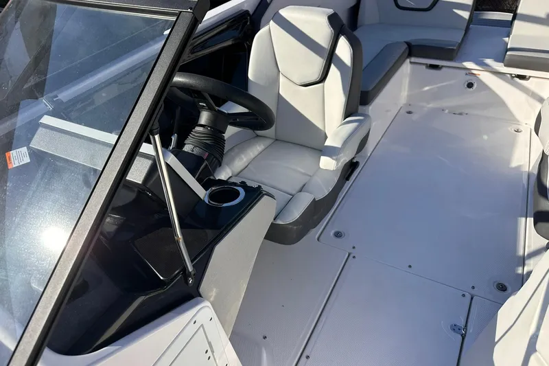 Slide: The Image of 2025 Yamaha Boats AR250 interior with steering wheel and seating area. - 4