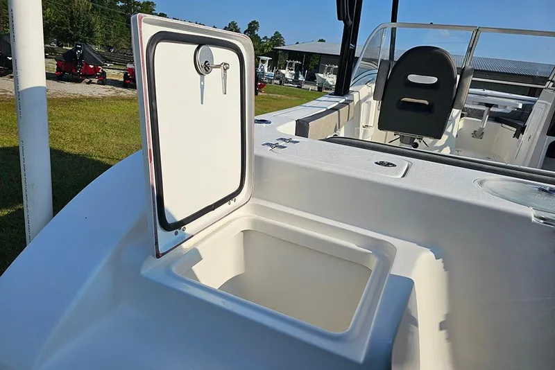 Slide: The Image of 2026 Sea Pro 240 Dual Console Sport boat with open storage compartment and seating area. - 11