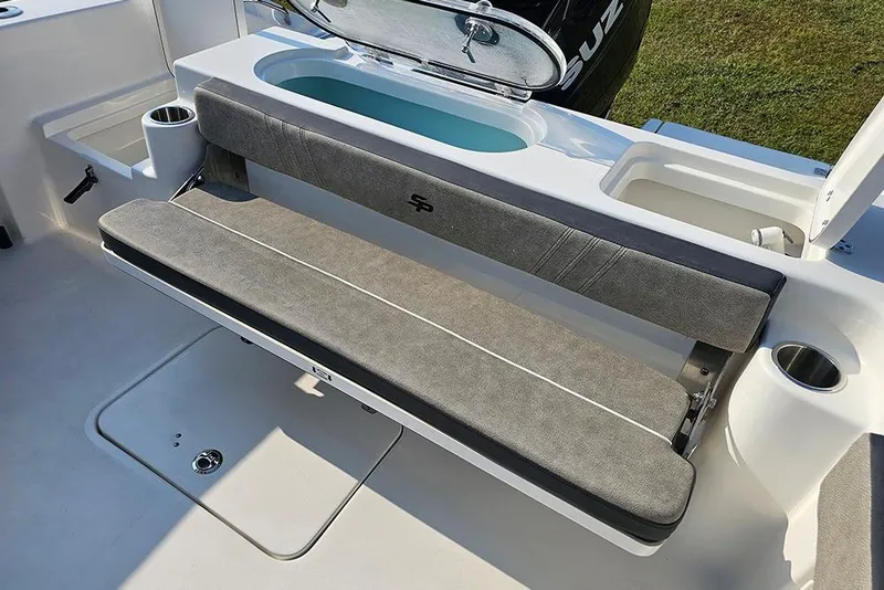 Slide: The Image of 2026 Sea Pro 240 Dual Console Sport boat interior with cushioned seating and storage compartments. - 16