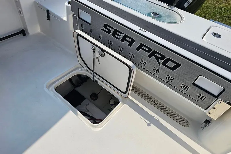 Slide: The Image of 2026 Sea Pro 240 Dual Console Sport boat interior with open storage compartment. - 17