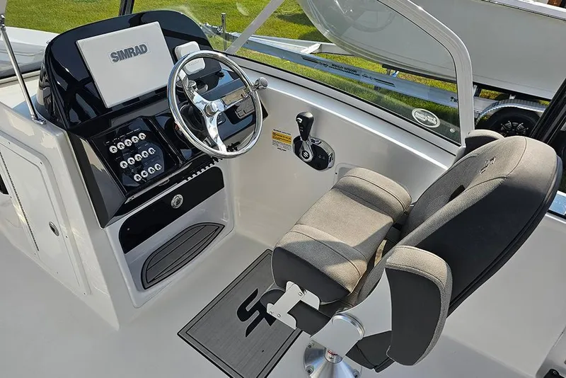 Slide: The Image of 2026 Sea Pro 240 Dual Console Sport boat interior with steering wheel and control panel. - 22