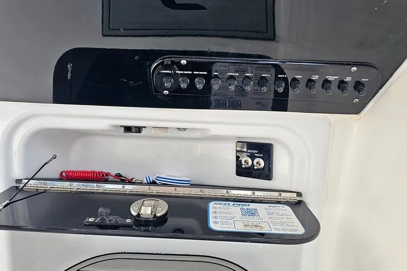 Slide: The Image of Control panel of 2026 Sea Pro 240 Dual Console Sport boat with switches and labels. - 24