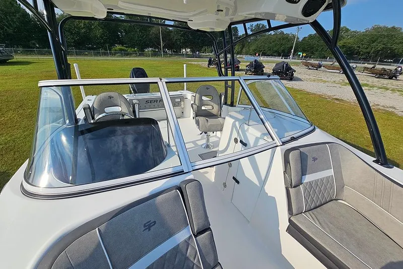 Slide: The Image of 2026 Sea Pro 240 Dual Console Sport boat interior with seating and dashboard. - 31