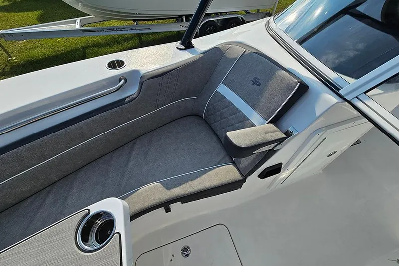 Slide: The Image of 2026 Sea Pro 240 Dual Console Sport boat interior with gray seating and cup holder. - 32