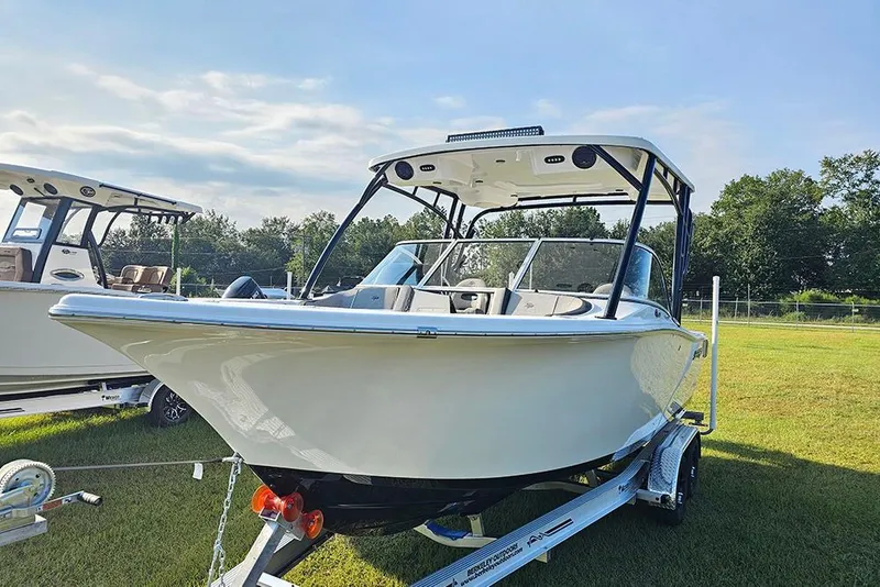 Slide: The Image of 2026 Sea Pro 240 Dual Console Sport boat on trailer, displayed outdoors. - 5