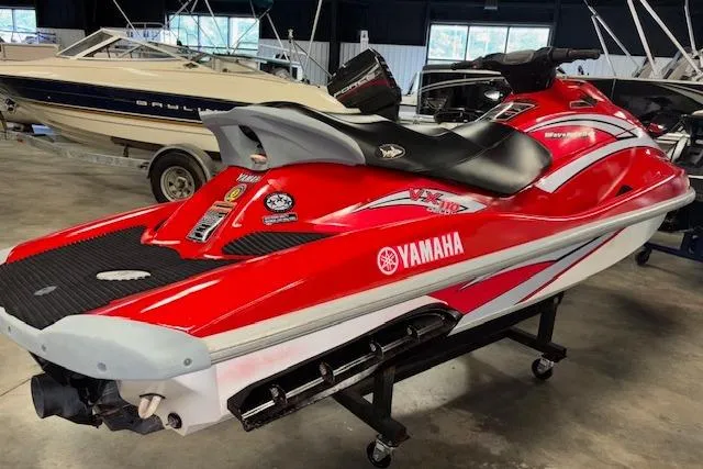 Slide: The Image of 2005 Yamaha WaveRunner VX 110 Deluxe, red and white jet ski in a showroom. - 7