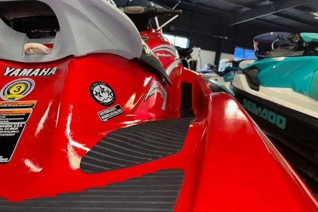 Slide: The Image of 2005 Yamaha WaveRunner VX 110 Deluxe, red, in showroom with other watercraft. - 9