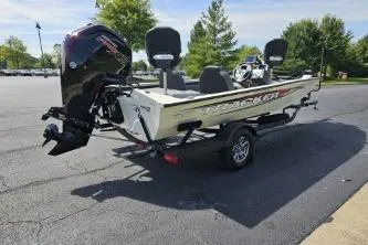 Slide: The Image of 2025 Tracker Pro Team 190 TX Tournament Edition boat on paved road, scenic background. - 5