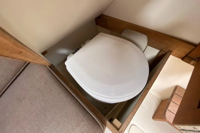 Slide: The Image of 1989 Blackfin 27 Fisherman boat interior with compact toilet setup. - 14