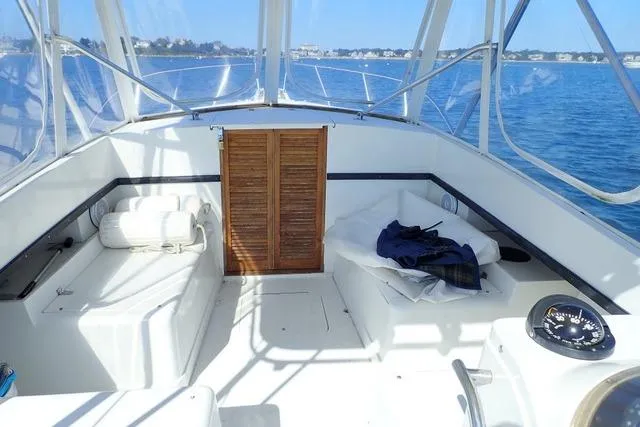 Slide: The Image of 1989 Blackfin 27 Fisherman boat interior with seating, compass, and clear ocean view. - 3