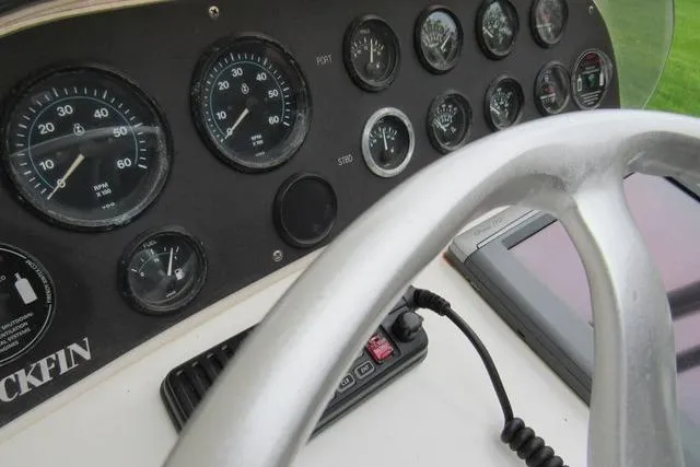 Slide: The Image of Dashboard of a 1989 Blackfin 27 Fisherman boat with gauges and steering wheel. - 5