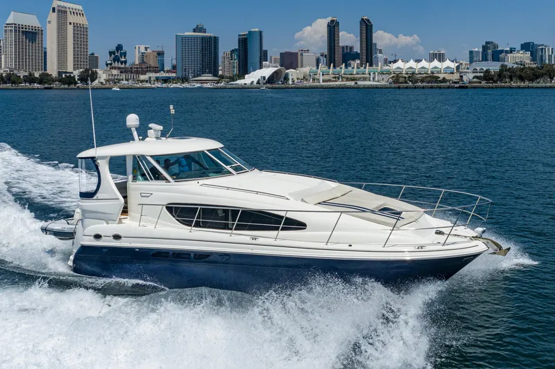 Slide: The Image of 2005 Sea Ray 390 Motor Yacht cruising near city skyline on a sunny day. - 1