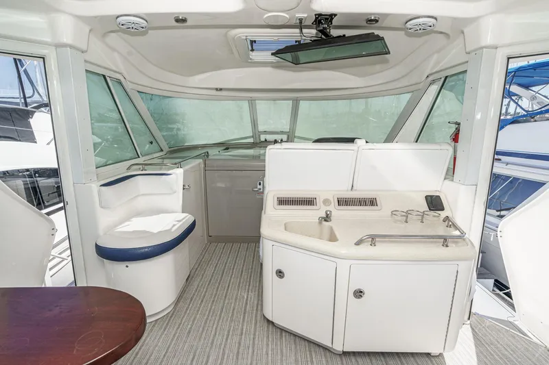 Slide: The Image of 2005 Sea Ray 390 Motor Yacht interior with seating and kitchenette area. - 14