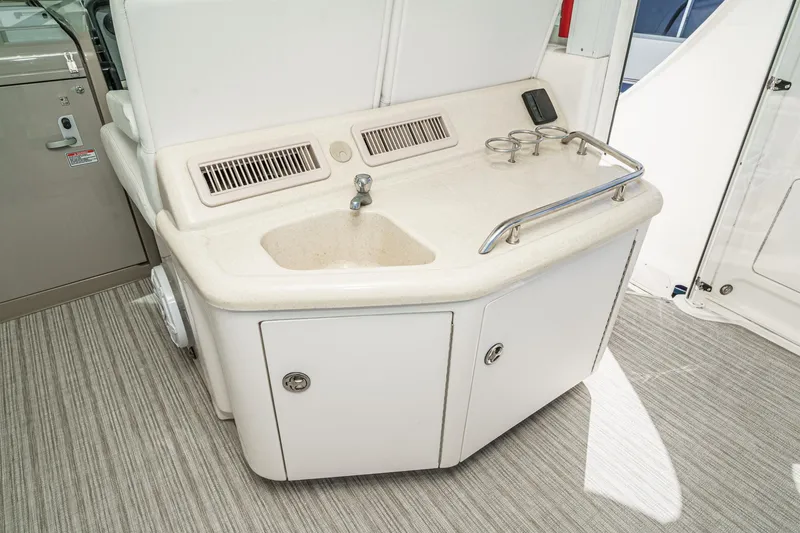 Slide: The Image of 2005 Sea Ray 390 Motor Yacht wet bar with sink and cup holders. - 15