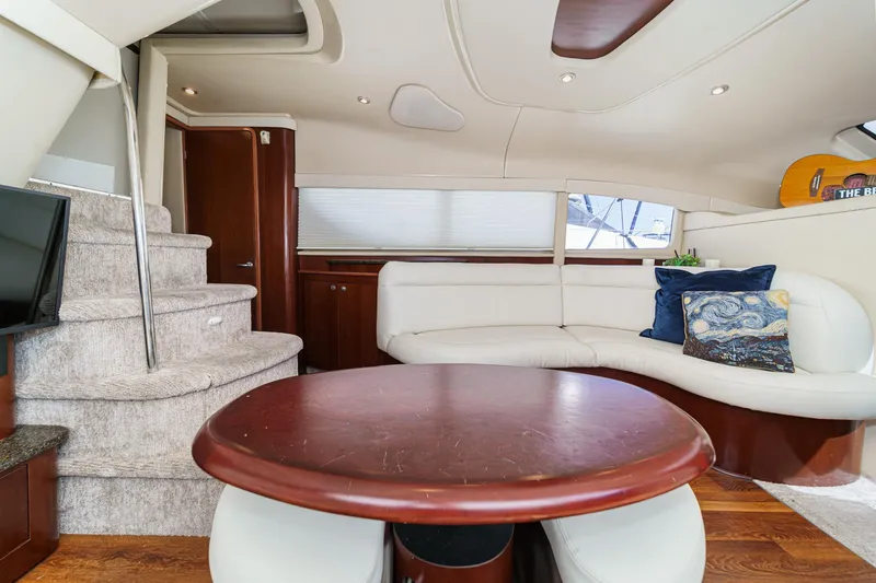 Slide: The Image of Interior of 2005 Sea Ray 390 Motor Yacht with plush seating and elegant wood finishes. - 26