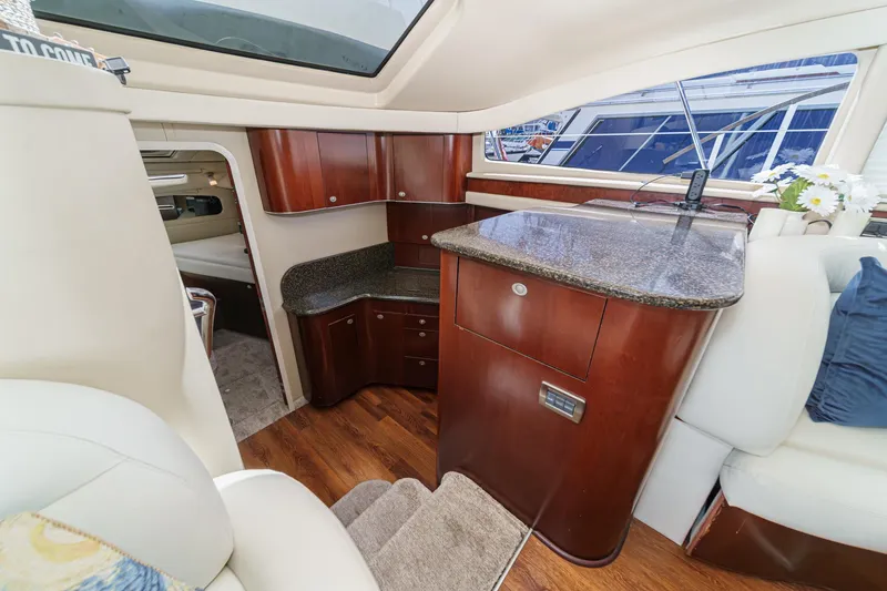 Slide: The Image of Interior of 2005 Sea Ray 390 Motor Yacht with elegant wood cabinetry and granite countertops. - 27