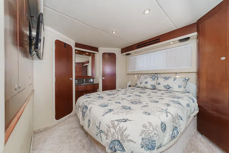 Slide: The Image of Luxurious 2005 Sea Ray 390 Motor Yacht bedroom with elegant bedding and wood accents. - 33