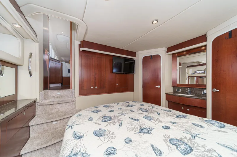 Slide: The Image of Luxurious 2005 Sea Ray 390 Motor Yacht bedroom with elegant wood finishes and cozy bedding. - 35