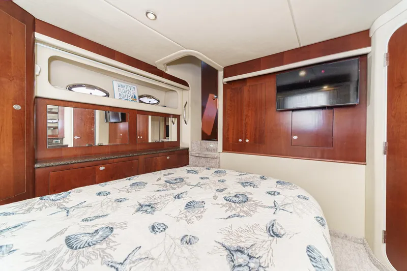 Slide: The Image of Luxurious 2005 Sea Ray 390 Motor Yacht bedroom with elegant wood finishes and nautical decor. - 36