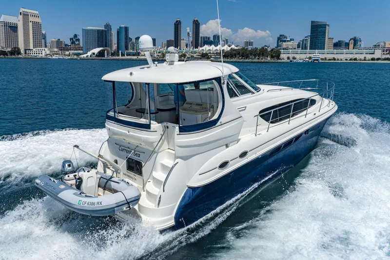 Slide: The Image of 2005 Sea Ray 390 Motor Yacht cruising near city skyline on a sunny day. - 4