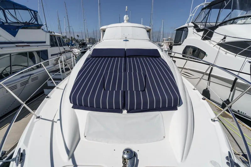 Slide: The Image of 2005 Sea Ray 390 Motor Yacht with striped sun pads docked at marina. - 6