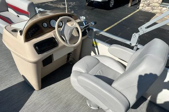 Slide: The Image of Captain's seat and dashboard of a 2000 Sweetwater 2019 EL boat. - 12