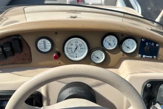 Slide: The Image of Dashboard of a 2000 Sweetwater 2019 EL boat with gauges and controls. - 14
