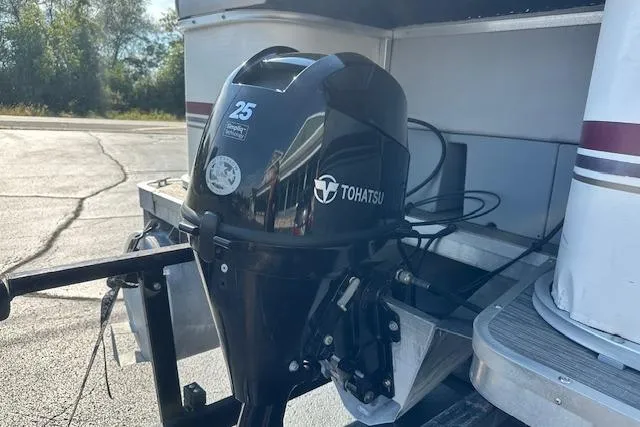 Slide: The Image of Tohatsu outboard motor on Sweetwater 2019 EL boat, parked outdoors. - 19