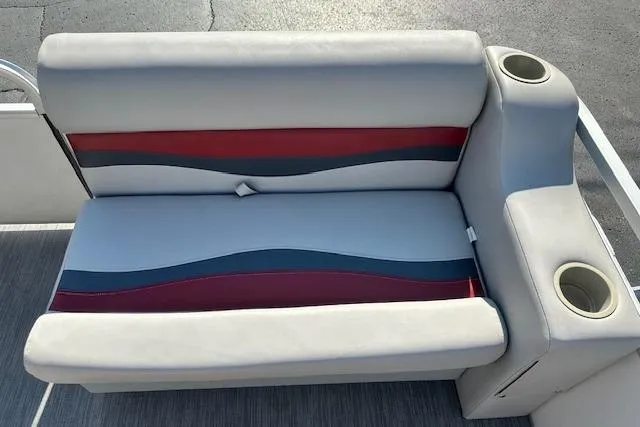 Slide: The Image of Sweetwater 2019 EL boat seat with cup holders, featuring red and blue wave design. - 6