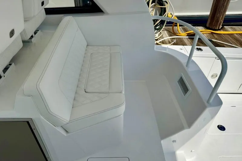 Slide: The Image of 2026 Intrepid 50 boat interior with white cushioned seating and sleek design. - 11