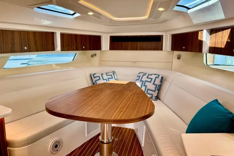 Slide: The Image of Luxurious interior of 2026 Intrepid 50 yacht with elegant wood finishes and plush seating. - 12