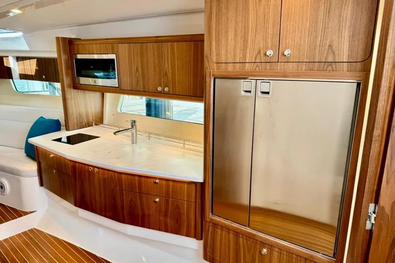 Slide: The Image of Luxurious 2026 Intrepid 50 yacht interior with modern kitchen and wood cabinetry. - 13