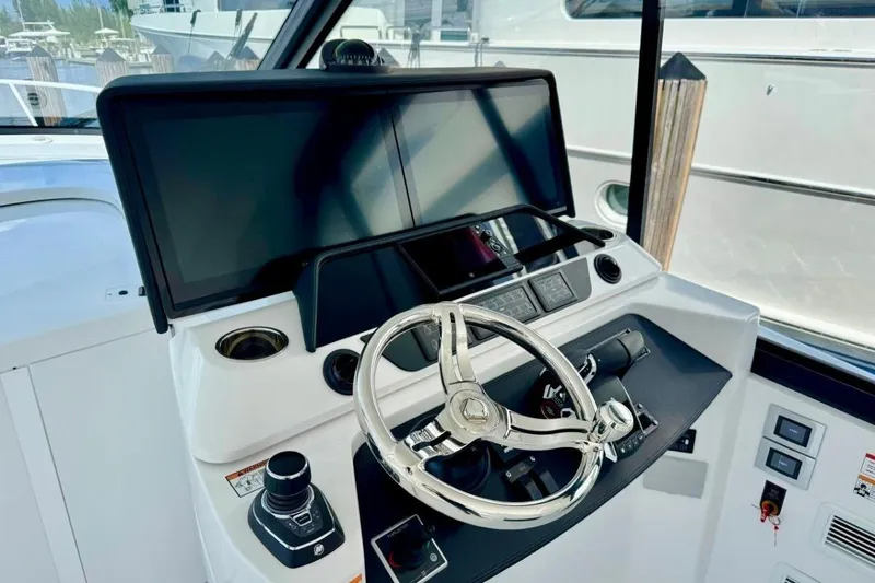 Slide: The Image of Helm of 2026 Intrepid 50 yacht with modern controls and dual screens. - 3