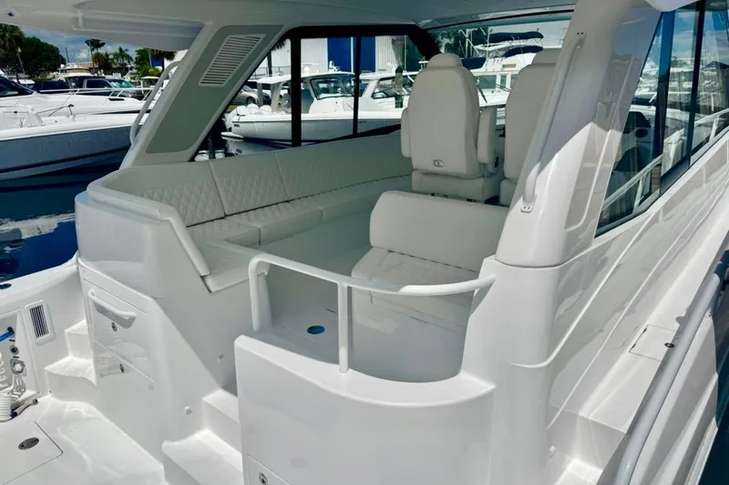 Slide: The Image of Luxurious 2026 Intrepid 50 yacht interior with sleek white seating and modern design. - 6