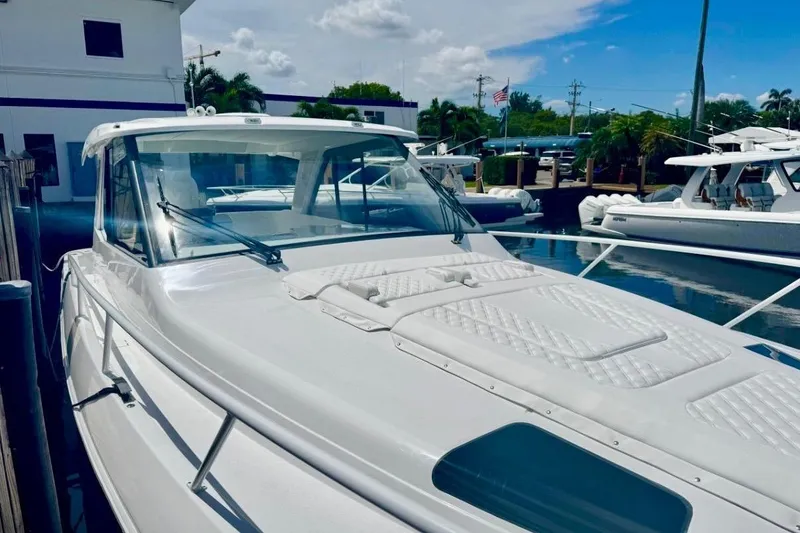 Slide: The Image of 2026 Intrepid 50 yacht docked at marina under clear blue sky. - 7