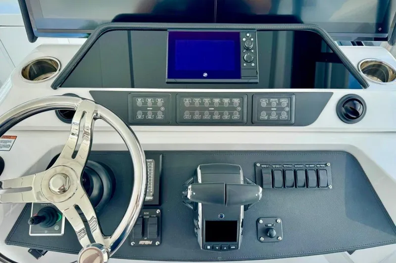 Slide: The Image of Helm of 2026 Intrepid 50 boat with modern controls and steering wheel. - 9