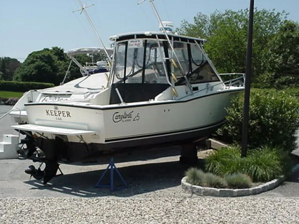 The Image of 2001 Carolina Classic 25 boat on display, parked on a stand outdoors. - 0