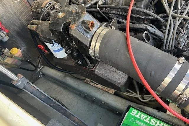 Slide: The Image of Engine compartment of a 2001 Carolina Classic 25 Classic boat, showing mechanical components. - 12