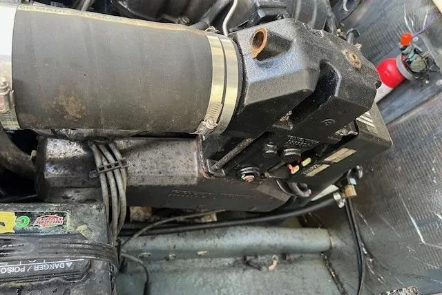 Slide: The Image of Engine compartment of a 2001 Carolina Classic 25 Classic boat, showing mechanical components. - 7