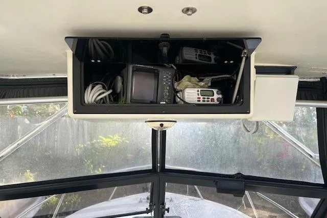 Slide: The Image of 2001 Carolina Classic 25 Classic boat dashboard with navigation equipment and radios. - 8