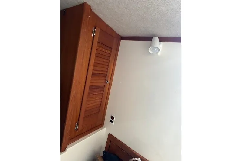 Slide: The Image of Interior of 2001 Carolina Classic 25 Classic boat with wooden cabinet and wall light. - 9