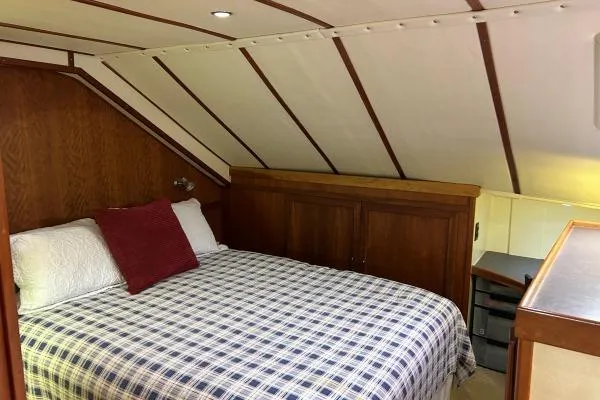 Slide: The Image of Cozy cabin interior of 2001 Crosswater Passagemaker 49 with plaid bedding and wooden accents. - 10