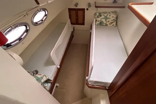 Slide: The Image of Cabin interior of 2001 Crosswater Passagemaker 49 with twin beds and portholes. - 11