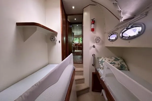 Slide: The Image of Interior of 2001 Crosswater Passagemaker 49 yacht with cozy sleeping area and portholes. - 12