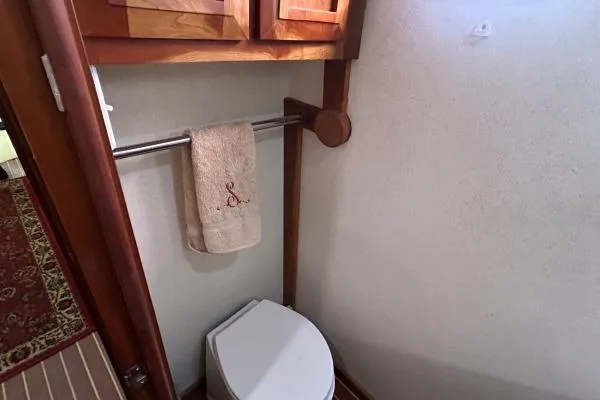 Slide: The Image of Bathroom interior of 2001 Crosswater Passagemaker 49 yacht, featuring a towel rack and toilet. - 14