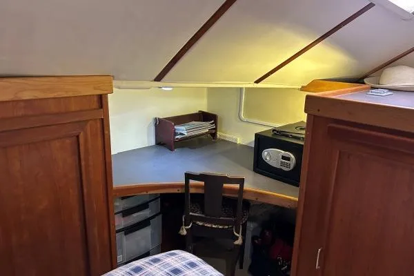 Slide: The Image of Cozy interior of 2001 Crosswater Passagemaker 49 with wooden cabinets and compact workspace. - 15