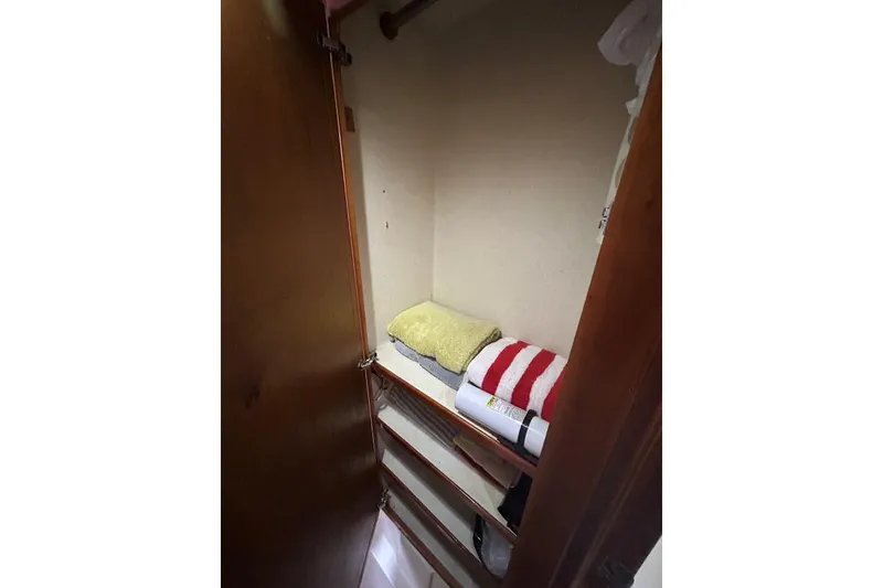Slide: The Image of Small storage closet with shelves and folded towels on a 2001 Crosswater Passagemaker 49. - 19