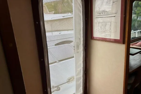 Slide: The Image of Interior view of 2001 Crosswater Passagemaker 49 with framed boat plans. - 22