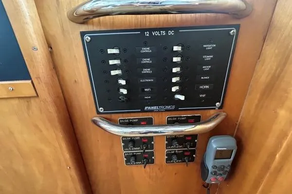 Slide: The Image of Electrical control panel on 2001 Crosswater Passagemaker 49 boat, featuring switches and bilge pump controls. - 25